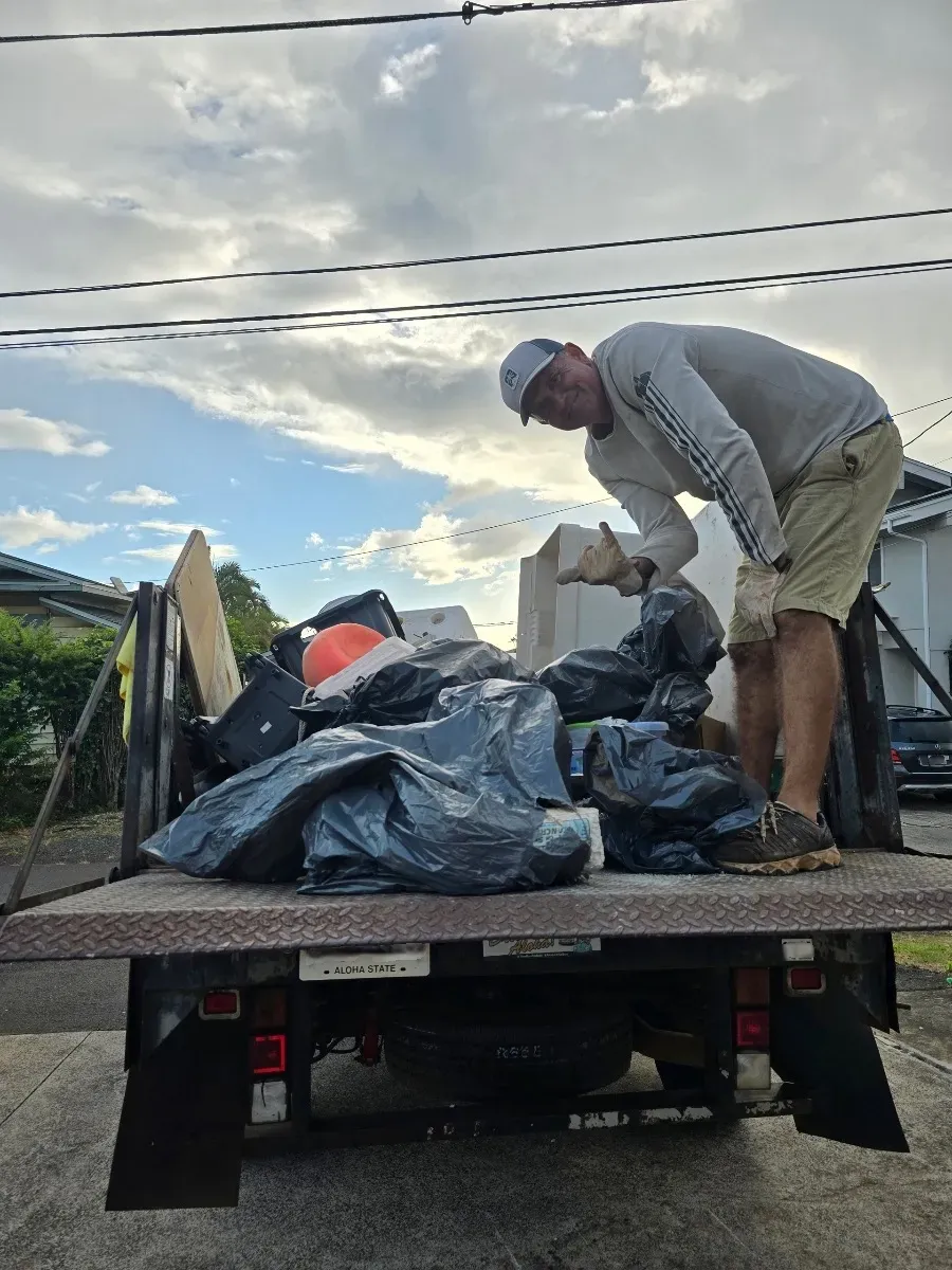 JunkForce team and company vehicle loaded with garbage